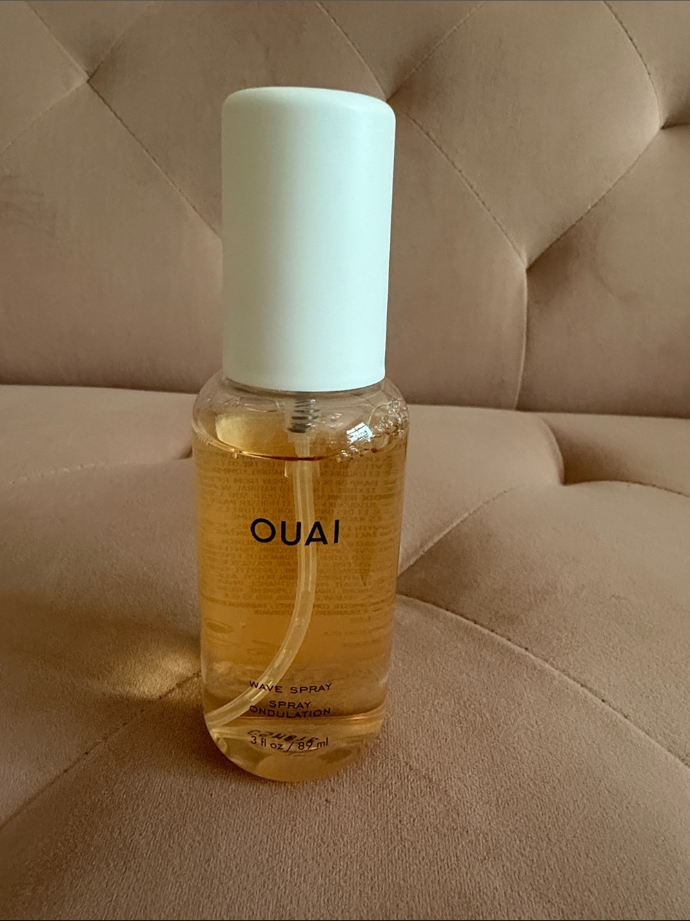 OUAI Wave Spray — White Cap with Amber Liquid